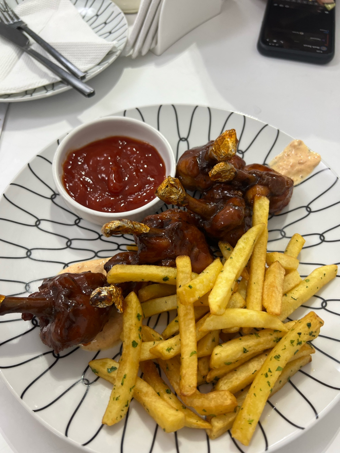 Chicken lollipops served with a side of fries